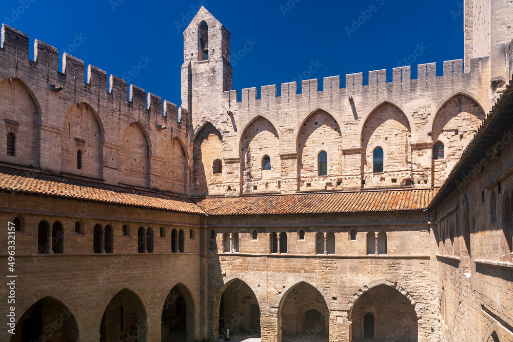 a historical castle standing under a blue sky in a sunny day in Avignon, France