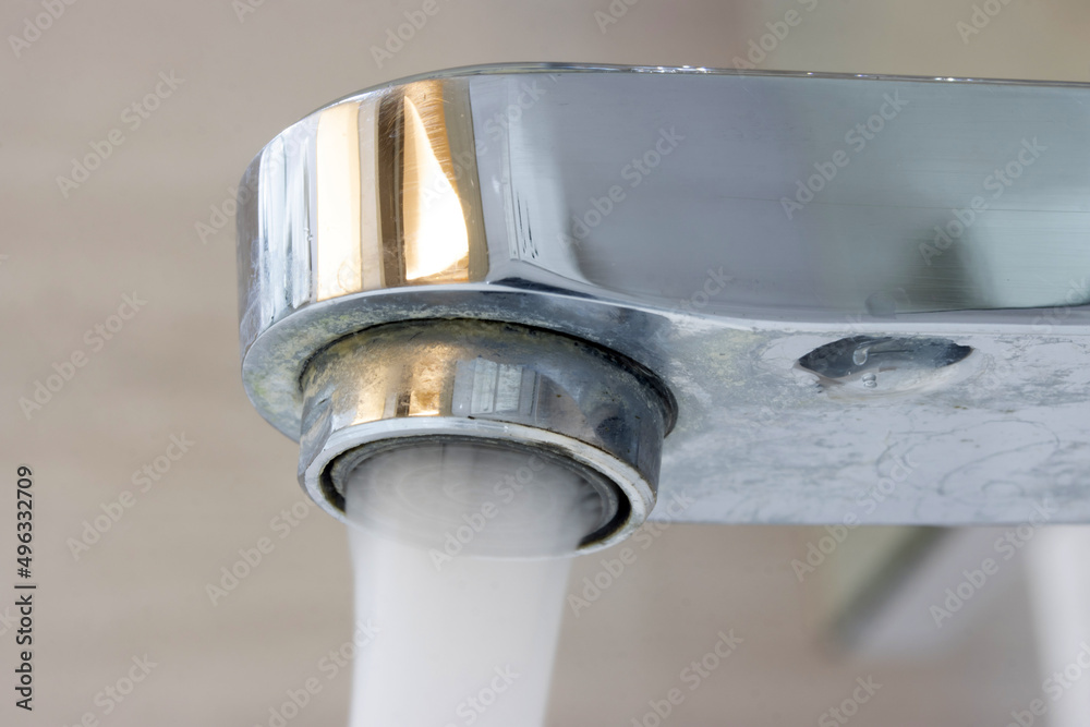 Water flowing from a water tap, macro view Water flowing from a water tap, macro view