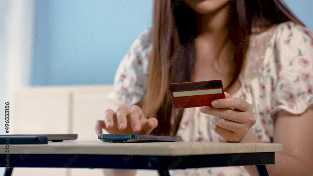 4K 50fps, Close-up of a beautiful Asian girl's hand red credit card to fill out card information Sit and shop online via mobile phone, to pay online via mobile phone. 4K 50fps, Close-up of a beautiful Asian girl's hand red credit card to fill out card information Sit and shop online via mobile phone, to pay online via mobile phone.