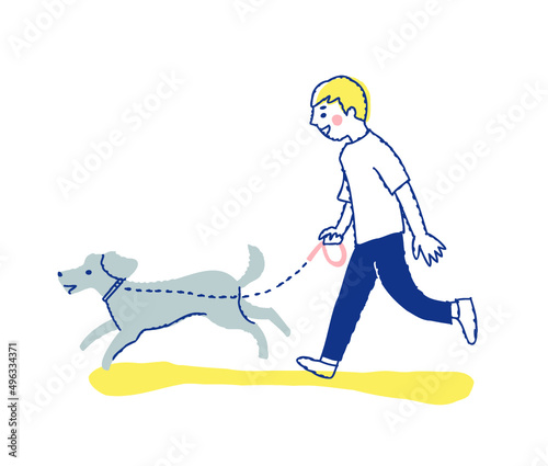 犬と散歩をしている若い男性