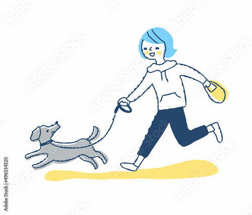 散歩中に一緒に走る犬と若い女性
