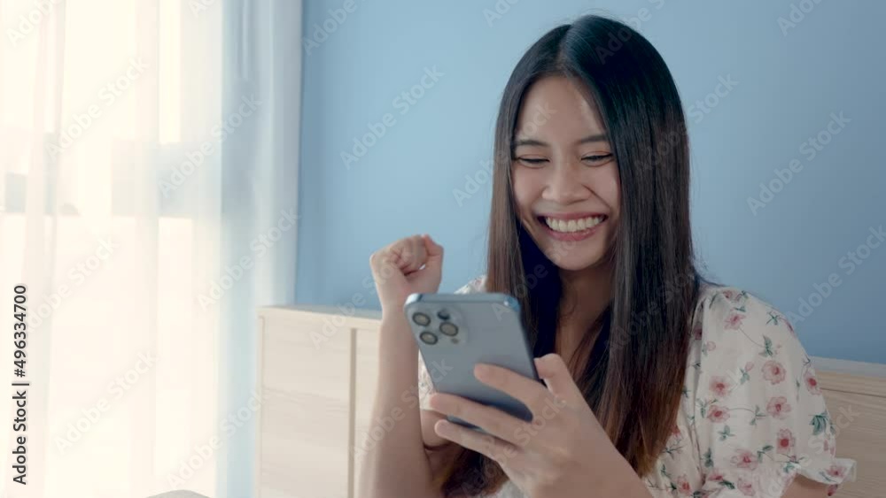 4K 50fps, close-up of a beautiful Asian girl express deep joy After successfully buying the products she likes through the phone online system. and use a credit card to pay for products happy face 4K 50fps, close-up of a beautiful Asian girl express deep joy After successfully buying the products she likes through the phone online system. and use a credit card to pay for products happy face