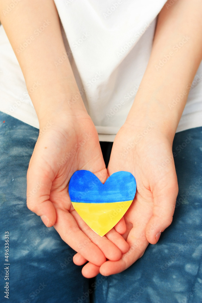 The child holds the Ukrainian heart in his hands