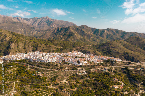 Perspective from above of beautiful typically Spanish village. White village situated in top of the hills in South of Spain. European, touristic travel destination in Andalucía. Drone perspective