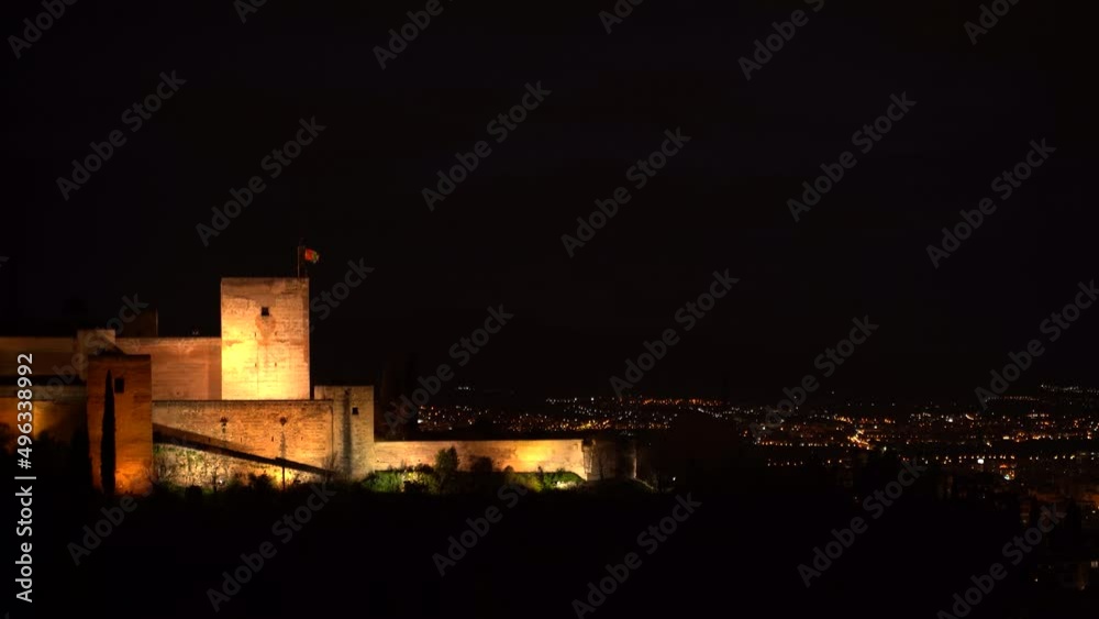 View over Alhambra Palace in Spain with city lights in background View over Alhambra Palace in Spain with city lights in background