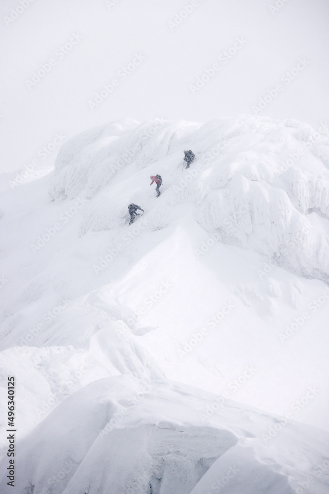 Group of alpinists trekking in harsh winter conditions in the Transylvanian Alps, Romania, Europe Group of alpinists trekking in harsh winter conditions in the Transylvanian Alps, Romania, Europe