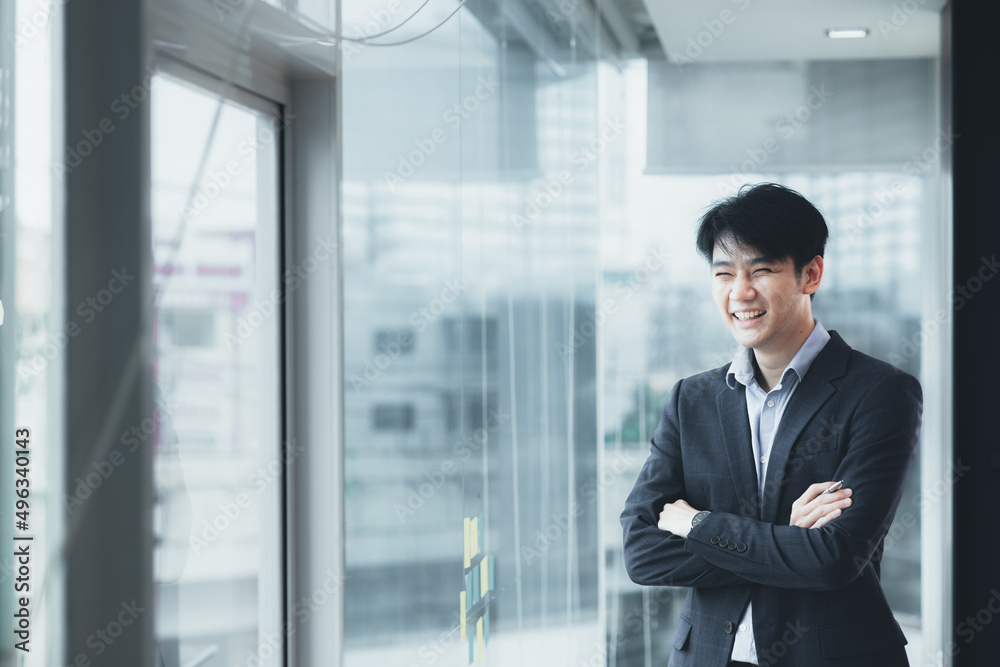 Fototapeta premium Asian man with suit, young businessman as startup company CEO, executive room, young startup company executives, run by young leaders. Management concept of startup companies and business men.