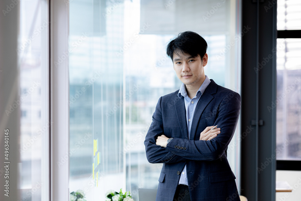 Asian man with suit, young businessman as startup company CEO, executive room, young startup company executives, run by young leaders. Management concept of startup companies and business men. Asian man with suit, young businessman as startup company CEO, executive room, young startup company executives, run by young leaders. Management concept of startup companies and business men.