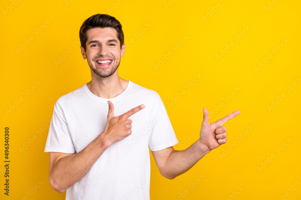 Photo of hooray millennial brunet guy indicate empty space wear white t-shirt isolated on yellow color background Photo of hooray millennial brunet guy indicate empty space wear white t-shirt isolated on yellow color background
