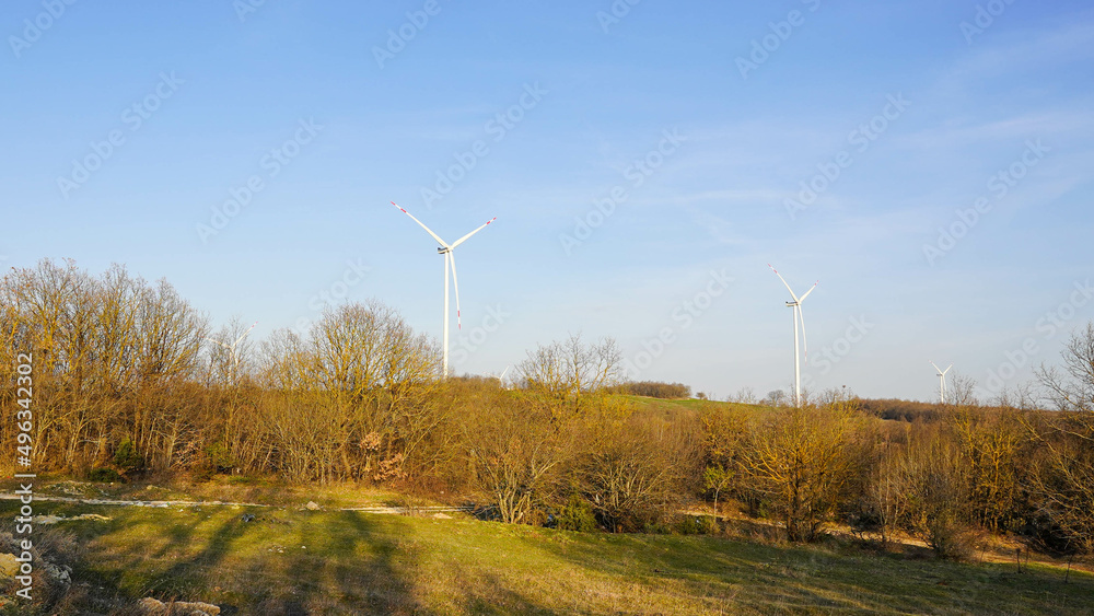 Wind energy turbines installed in the forest. Renewable natural energy source. Wind energy turbines installed in the forest. Renewable natural energy source.