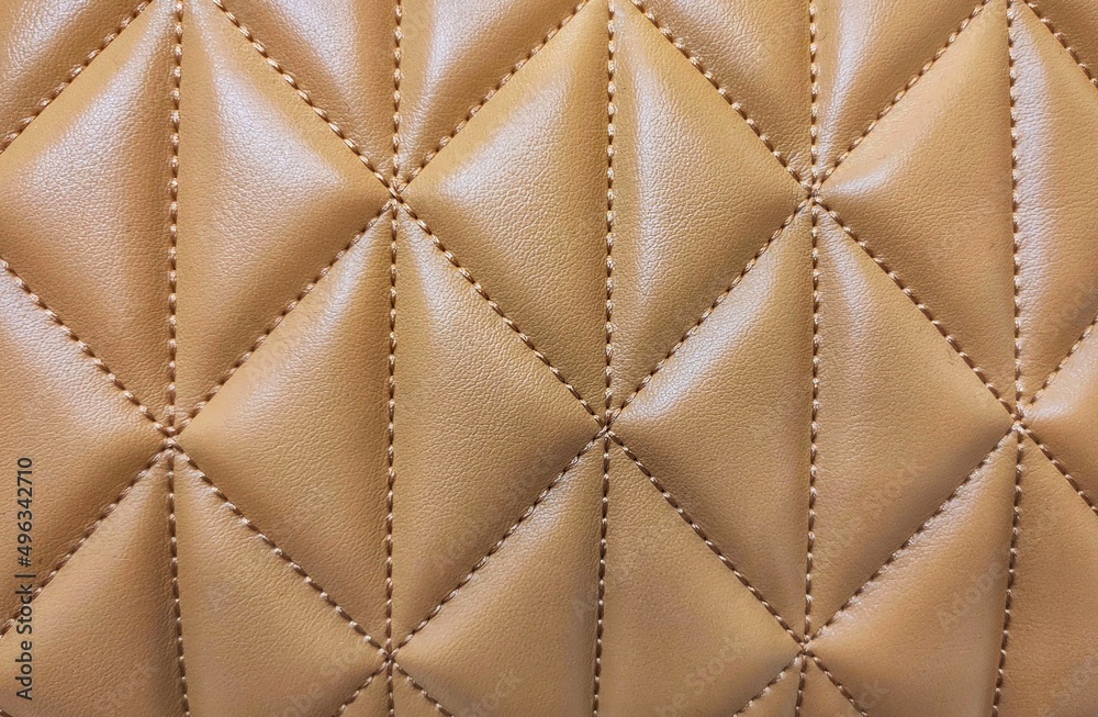 Fototapeta premium Soft beige leather texture with print as background, surface leather. 