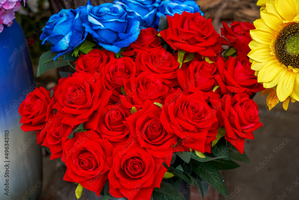 A bouquet of bright red beautiful roses fake flowers A bouquet of bright red beautiful roses fake flowers