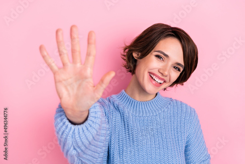 Portrait of cheerful adorable person hand palm five high five toothy smile isolated on pink color background