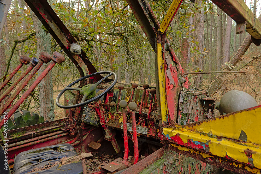 Cabin of an old abandoned tractor in the forest