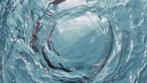 Super slow motion of water surface on light blue background. Filmed on high speed cinema camera, 1000 fps. photo