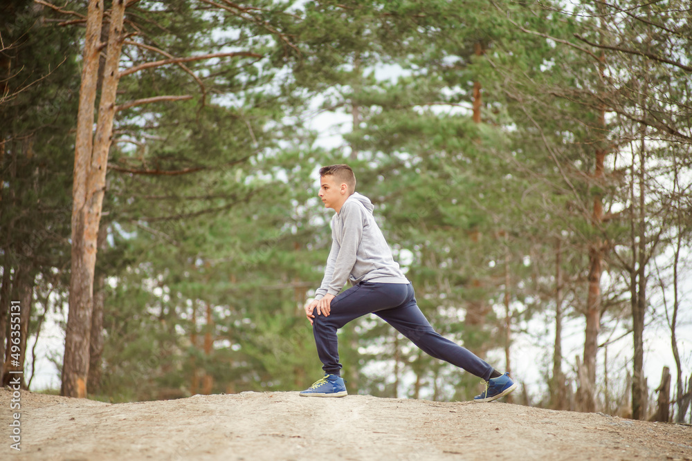 Fototapeta premium boy stretches the flexor leg muscles 