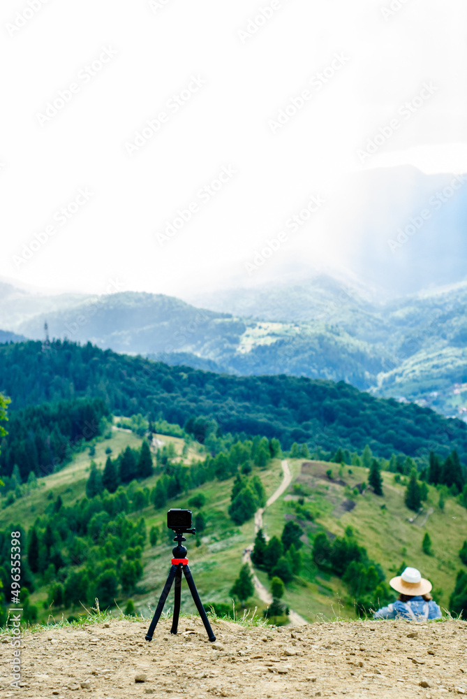 Time lapse shooting at the top of the mountain. Action camera on a tripod in the mountains. Shooting a beautiful mountain scenery while traveling. Ukrainian Carpathians Time lapse shooting at the top of the mountain. Action camera on a tripod in the mountains. Shooting a beautiful mountain scenery while traveling. Ukrainian Carpathians