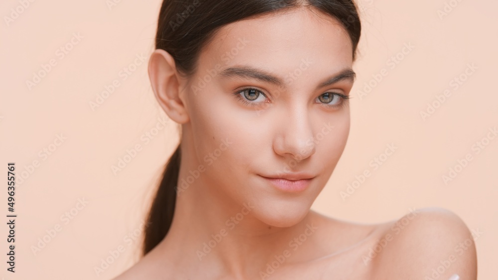 Close-up beauty portrait of young woman looking at camera | Body care and healthy skin. Close-up beauty portrait of young woman looking at camera | Body care and healthy skin.