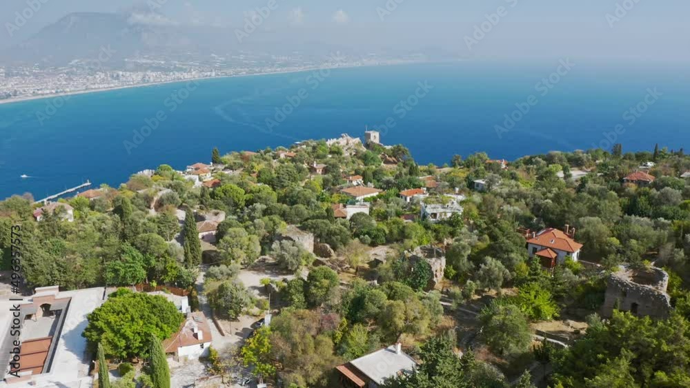 View of the Mediterranean Sea from the ruins of an old stone wall in Alanya, Turkey. Top view from drone. Alanya beach top view on the mountain with coast on blue sea and harbor city background View of the Mediterranean Sea from the ruins of an old stone wall in Alanya, Turkey. Top view from drone. Alanya beach top view on the mountain with coast on blue sea and harbor city background