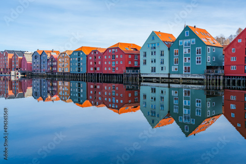 Colorful old wooden houses with reflections in the river Nidelva in the Brygge district of Trondheim, Norway