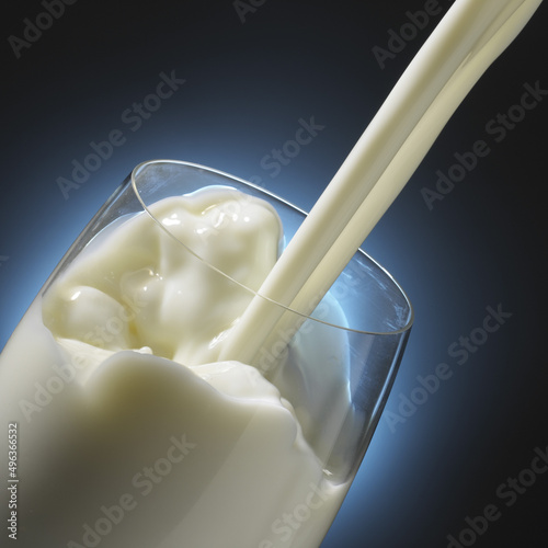 Close-up of milk being poured into a glass photo