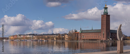 Panorama view with abstract sculpture on a parterre and the Town City Hall at the waterfront Norr Mälarstrand a sunny spring day in Stockholm