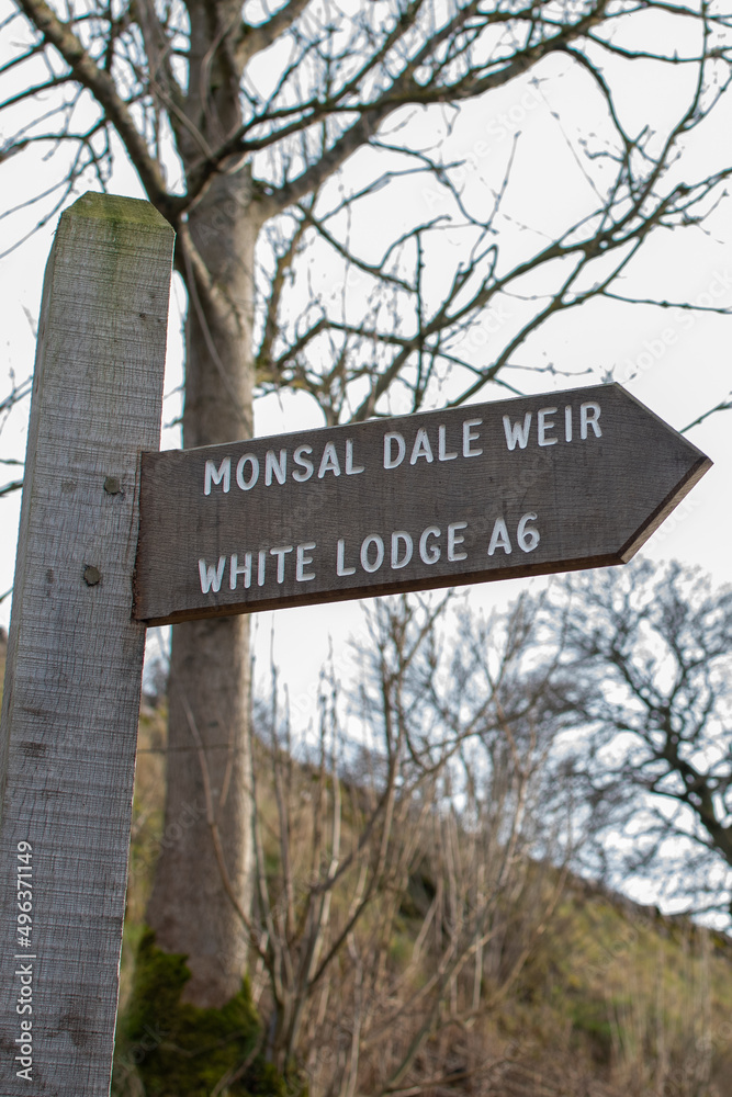 Sign post giving directions to Monsal Weir waterfall in the Peak District, Derbyshire