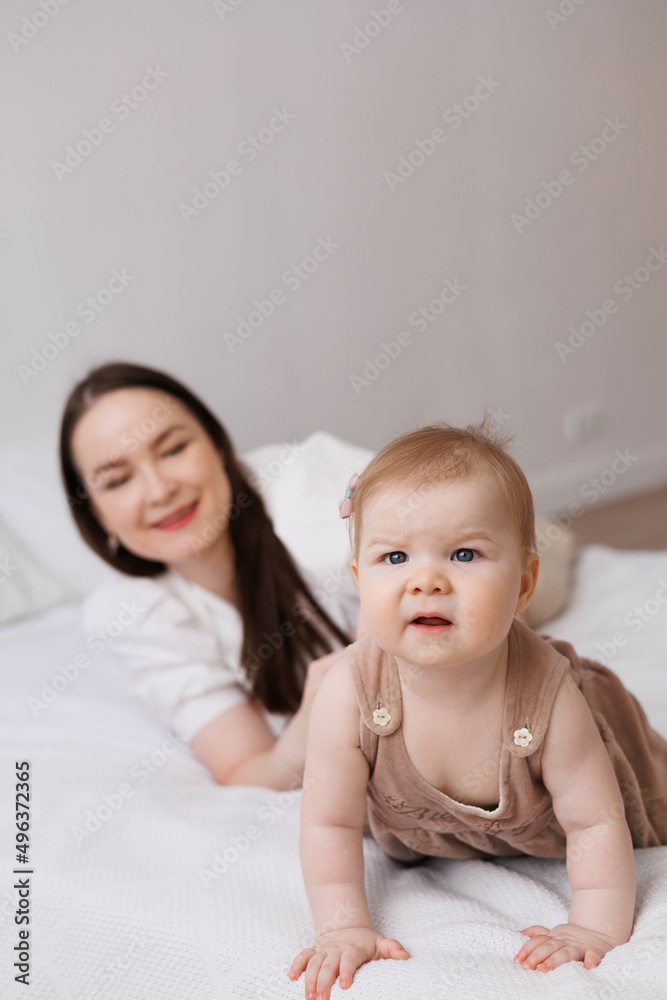 Sweet young mother holding her little 1-year-old daughter in hands.
Caring brunette woman laying with her baby child at home. Tenderness and love between mother and daughter. Lovely family indoors. Sweet young mother holding her little 1-year-old daughter in hands.
Caring brunette woman laying with her baby child at home. Tenderness and love between mother and daughter. Lovely family indoors.