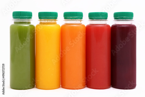 Fruit and Vegetable Juice in plastic Bottles isolated on white Background, copy space, mock up.