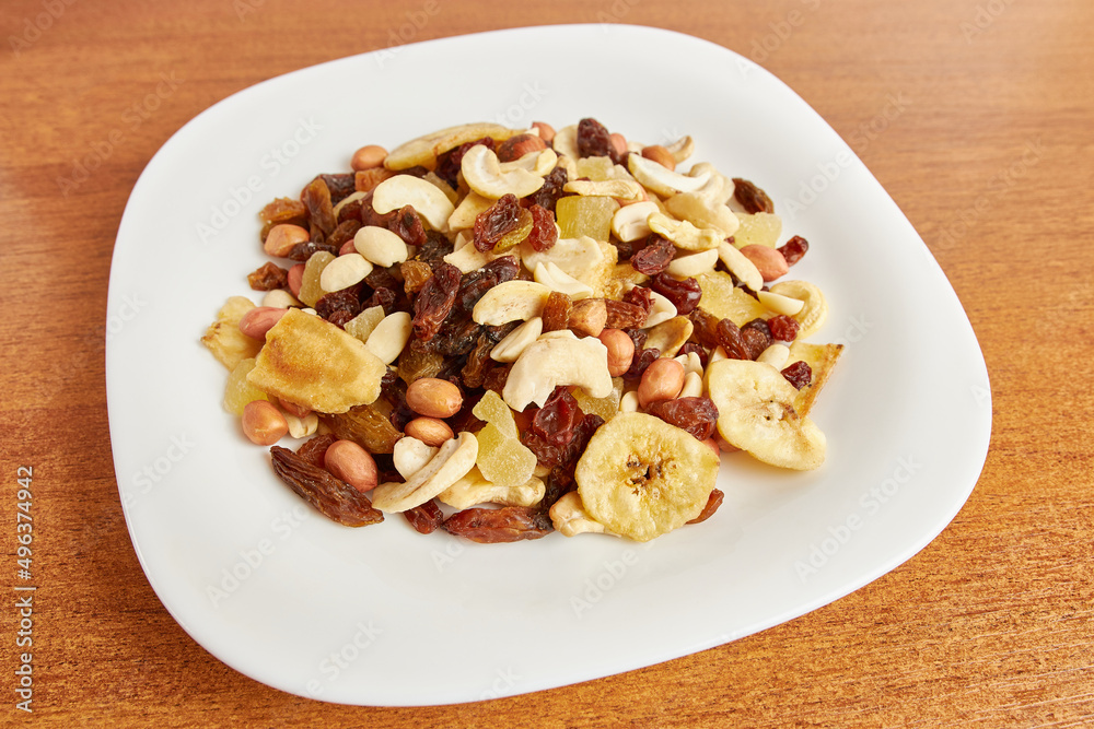 Assorted fruits and nuts. Dried healthy food. Dried grapes, peanuts, pineapple, banana, cashews, almonds. Assorted fruits and nuts. Dried healthy food. Dried grapes, peanuts, pineapple, banana, cashews, almonds.