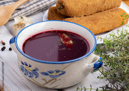 red borscht with croquettes in a blue pot