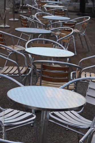 Gleaming metal tables with chairs © Timothy