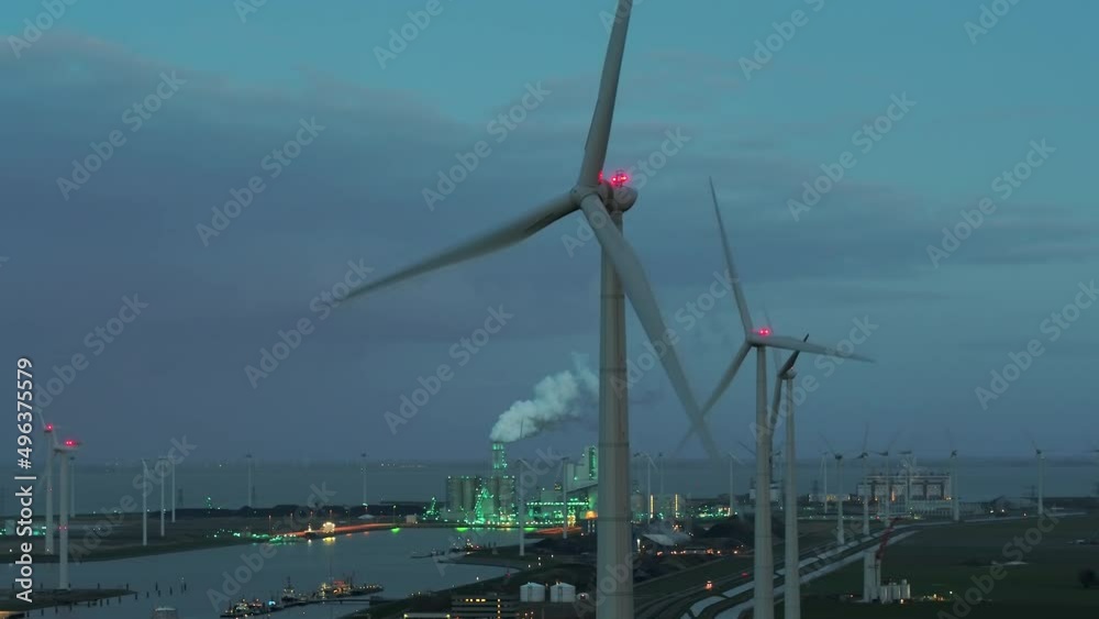 Wind turbine and power station at dusk, Eemshaven, Netherlands