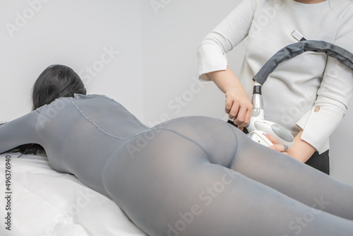 Cellulite and localised fat removal treatment on the buttocks, for younger and smoother skin. Woman receiving anti-ageing therapy with the LPG machine in a beauty salon. Body reshaping procedure.