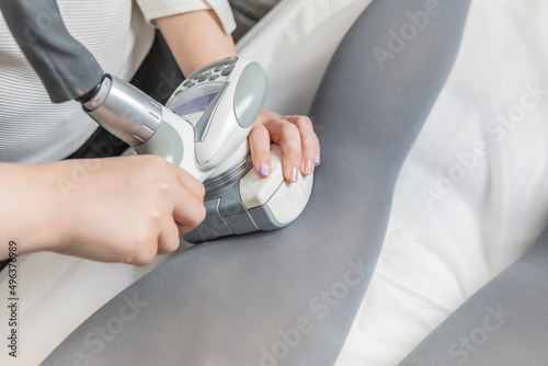 Cellulite and localised fat removal treatment on the legs , for younger and smoother skin. Woman receiving anti-ageing therapy with the LPG machine in a beauty salon.