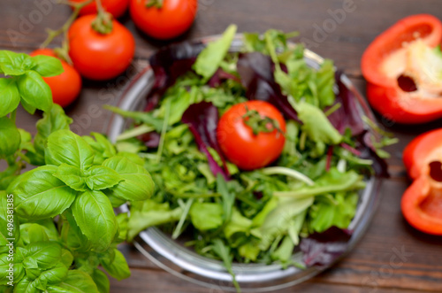 basil leaves close-up and herbs, tomatoes, ingredients for making salad