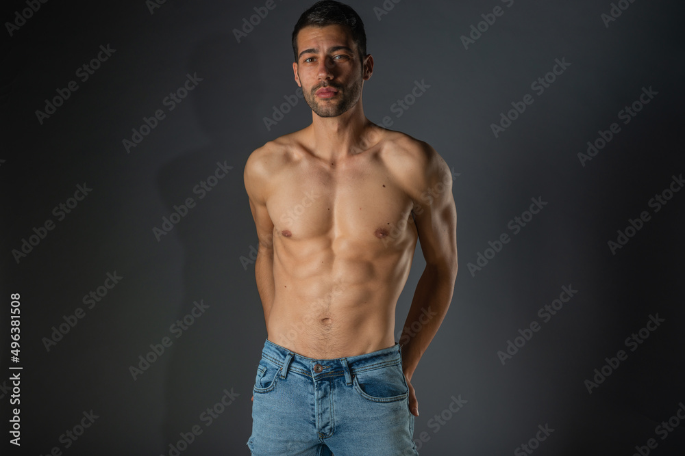 Portrait of an attractive stylish man posing against dark background Portrait of an attractive stylish man posing against dark background