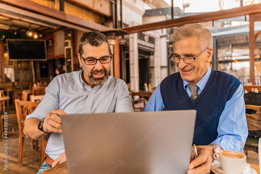Discussing and looking their ideas together on the lap top while smiling Discussing and looking their ideas together on the lap top while smiling