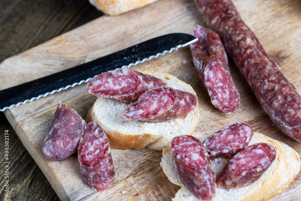 sliced pieces of sausage from meat are lying on a cutting board sliced pieces of sausage from meat are lying on a cutting board