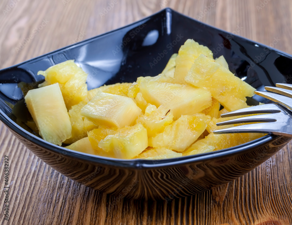 cut into pieces ripe yellow pineapple on the table cut into pieces ripe yellow pineapple on the table