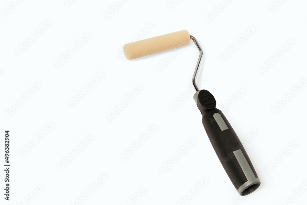 Paint roller with black handle. Painting surfaces with a paint roller. Paint roller with black handle. Painting surfaces with a paint roller.