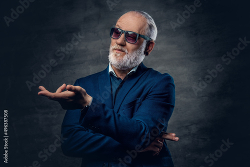 Confident and stylish aged man dressed in dark blue jacket