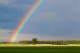 beautiful double rainbow in cloudy sky