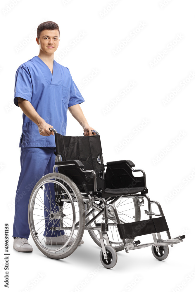 Young male nurse standing with an empty wheelchair