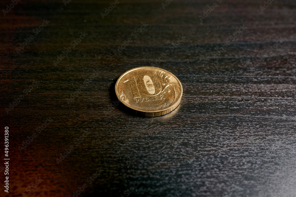 Golden coins of ten rubles on a black table Golden coins of ten rubles on a black table