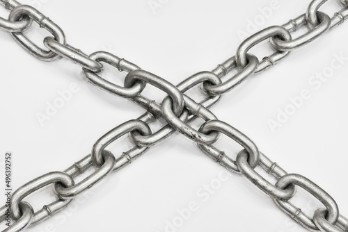 Old metal chain cross on white background. Concept of imprisonment, incarceration, detention, ban, isolation, lock.