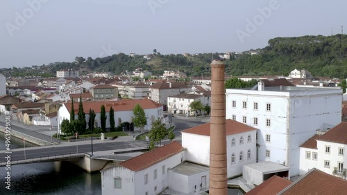 Tomar drone aerial view with nabao river and brick tower at sunrise, in Portugal photo