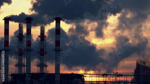 Industrial landscape, the pipes of the thermal power plant at sunset