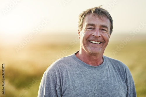 Ive always loved the fresh air. Portrait of a mature man standing outdoors. photo