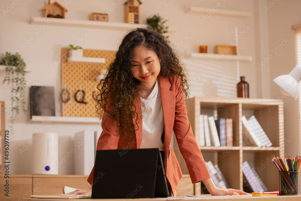 Asian Designer woman work from home and communicate with the design team over the internet. On a tablet,women are having a video conference call. Asian Designer woman work from home and communicate with the design team over the internet. On a tablet,women are having a video conference call.